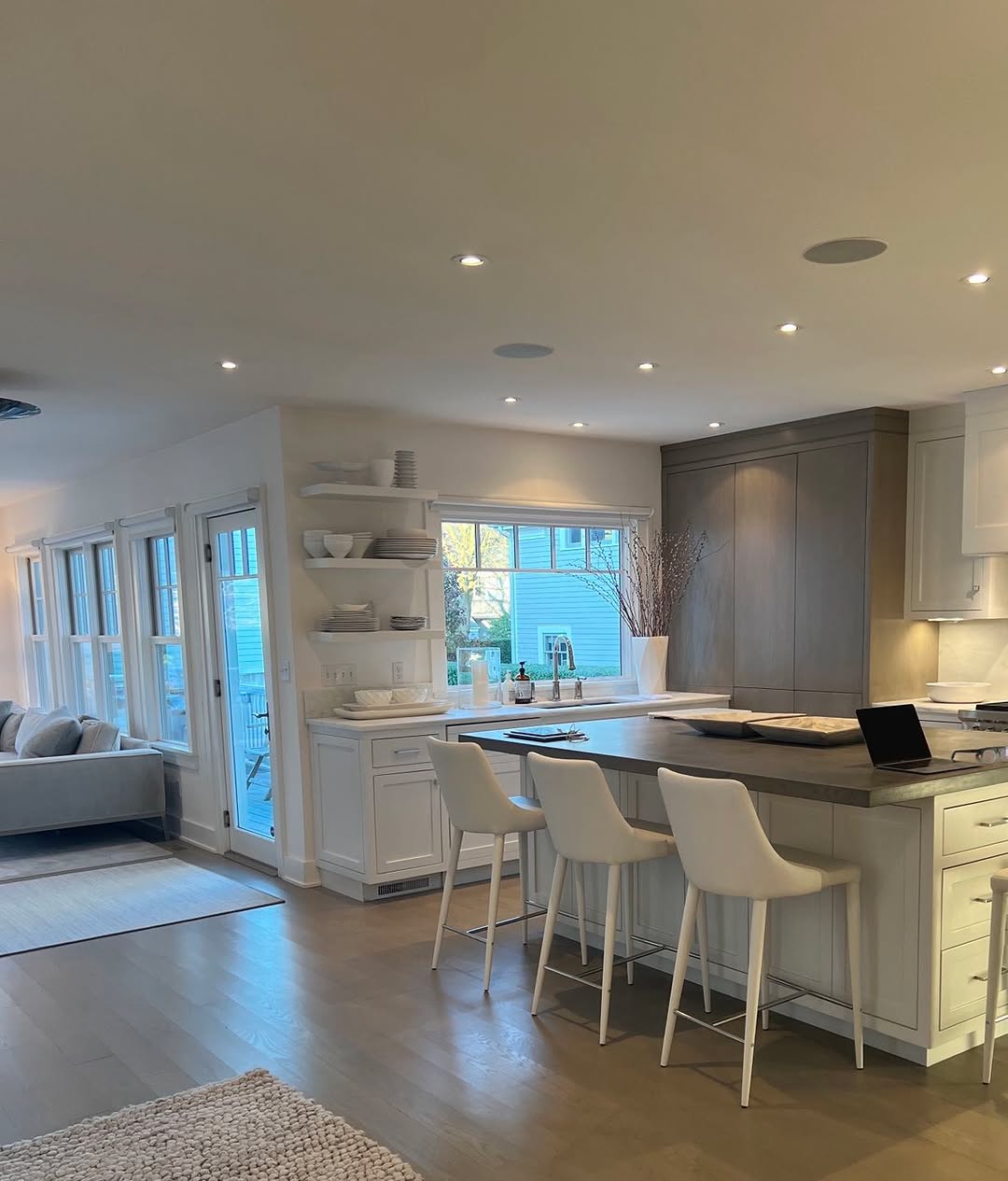 Coastal kitchen in white, open to the water side of the house