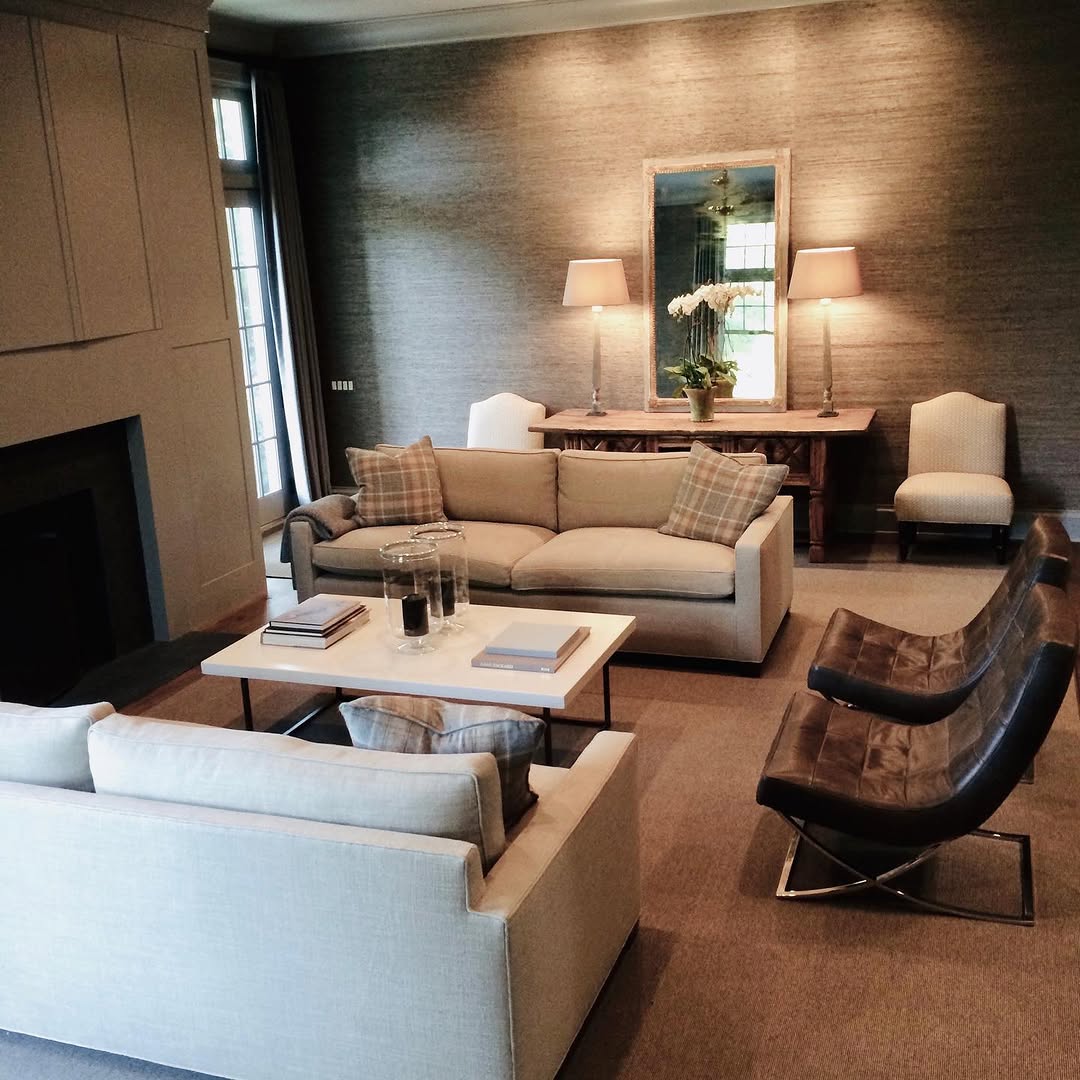 Living room in warm neutrals with grasscloth walls and a sculptural chair