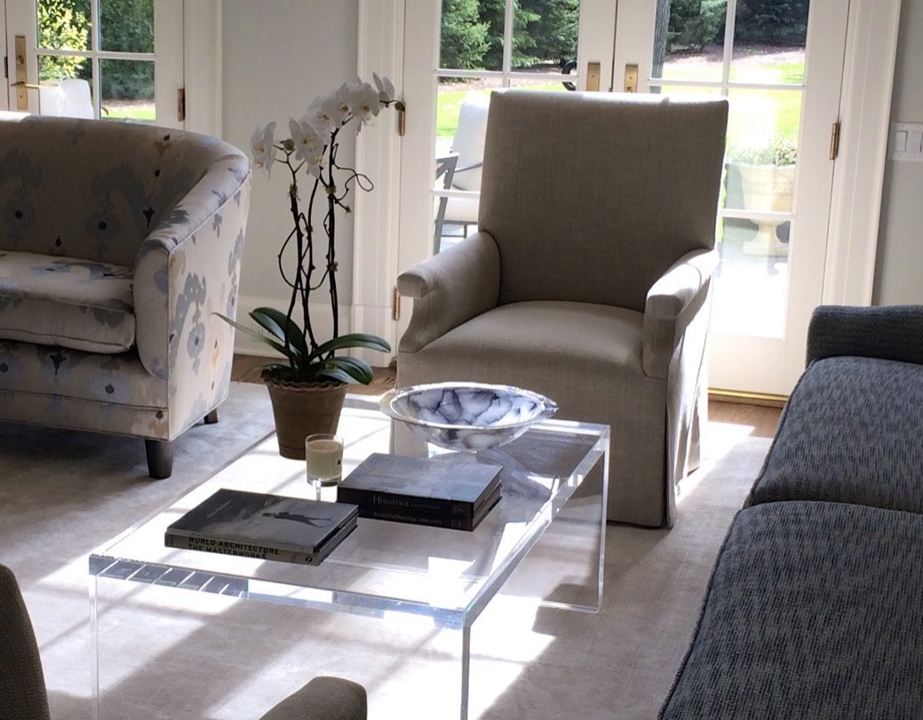 Sitting room with a pair of wing chairs and a lucite table