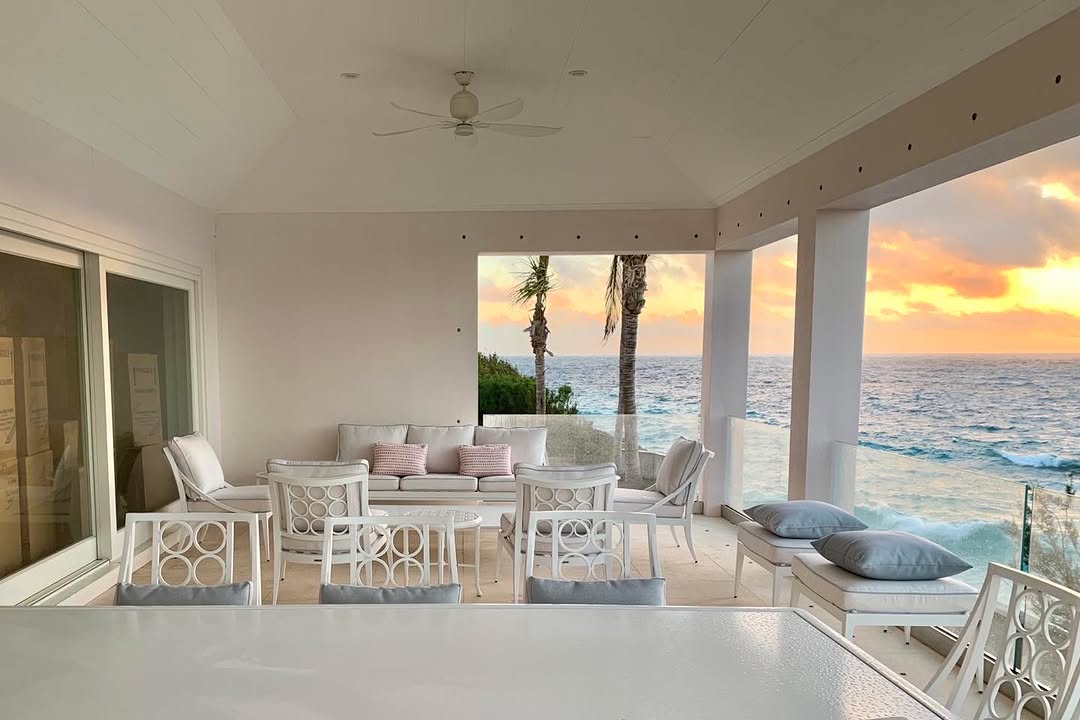 Covered terrace looking out to the ocean at sunset